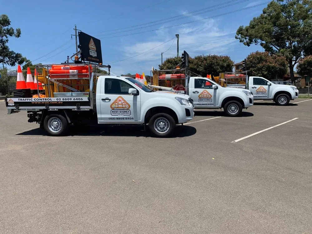 Three West Sydney Traffic Control utes fitted with arrow boards and cones